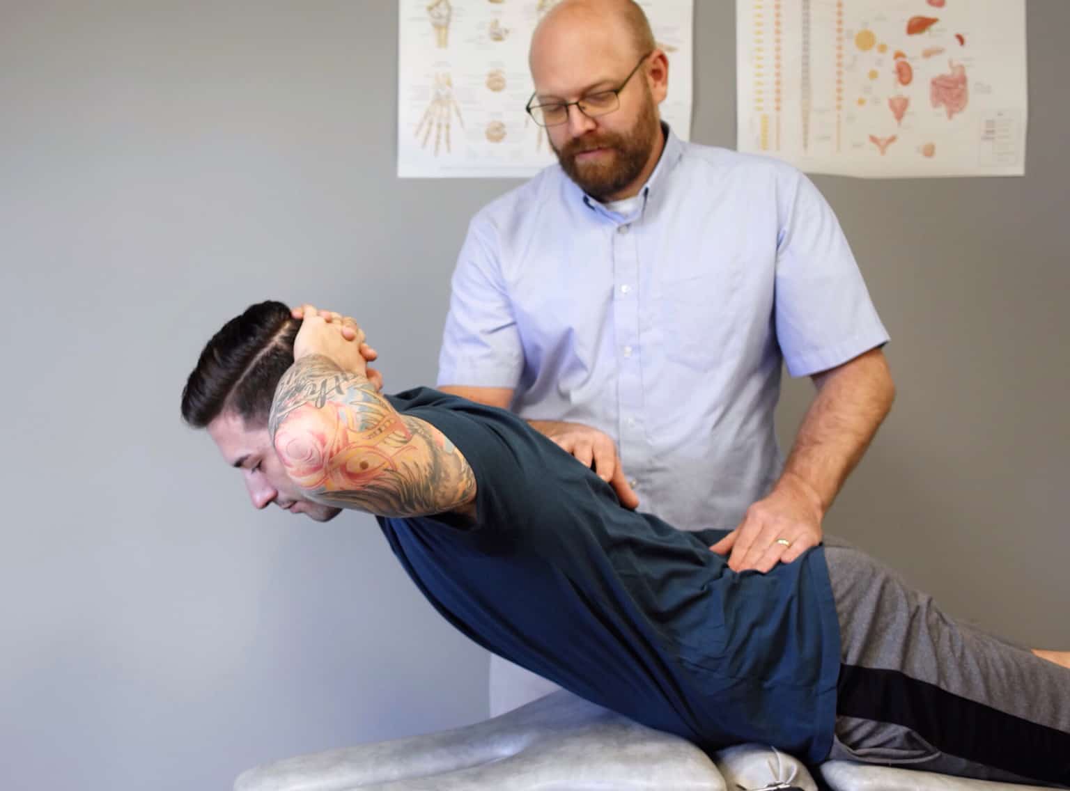 Physical-Therapist-Assessing-Back-Pain Physical-Therapist-Assessing-Back-Pain