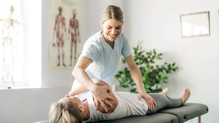 Modern rehabilitation physiotherapy worker with woman client